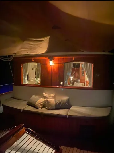 Iduna Yacht Photos Pics Classic 1939 Feadship sailing yacht interior with cozy seating and warm lighting.