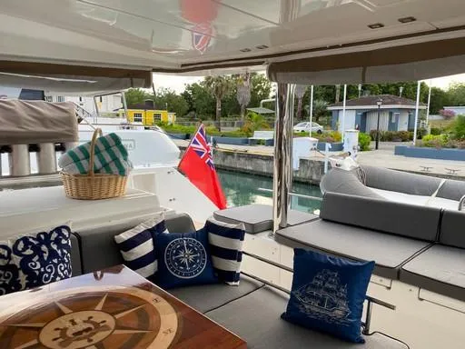 Recipe Yacht Photos Pics Luxurious Lagoon 560 yacht interior with nautical decor, docked at a serene marina.