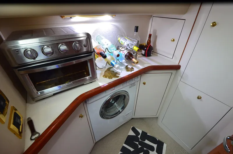 Escape Yacht Photos Pics Kitchen area of 2000 Sea Ray 420 Aft Cabin with oven and washing machine.