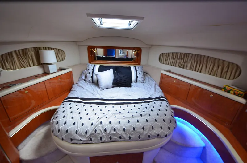 Escape Yacht Photos Pics Luxurious bedroom interior of 2000 Sea Ray 420 Aft Cabin yacht with elegant bedding.