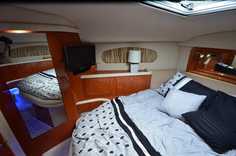 Escape Yacht Photos Pics Luxurious cabin interior of 2000 Sea Ray 420 Aft Cabin yacht with cozy bedding.