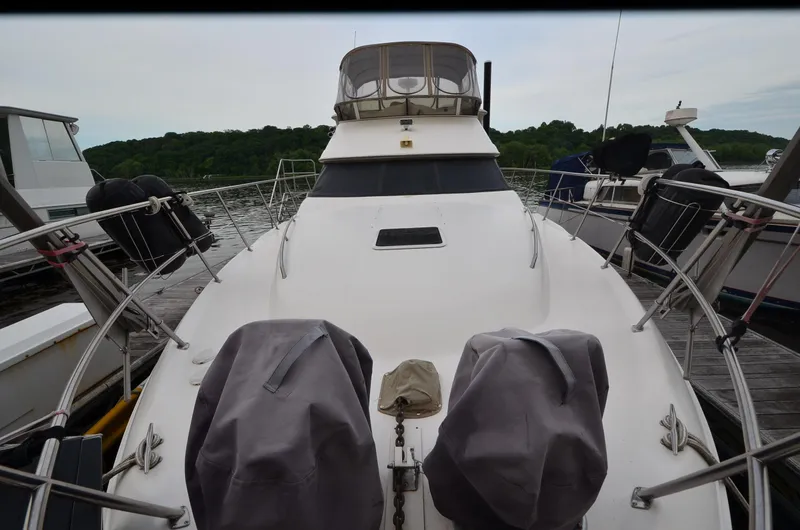 Escape Yacht Photos Pics 2000 Sea Ray 420 Aft Cabin yacht docked at marina, surrounded by other boats.