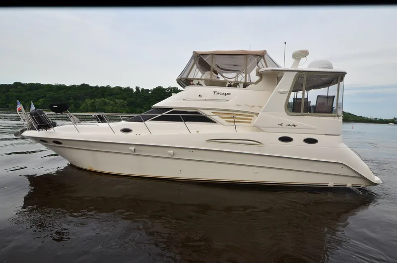 Escape Yacht Photos Pics 2000 Sea Ray 420 Aft Cabin yacht on calm water, side view.