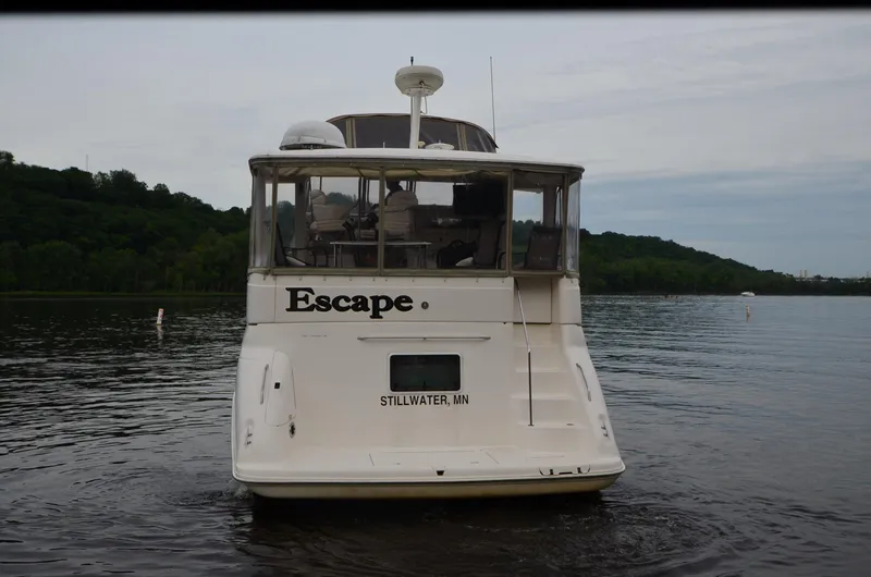 Escape Yacht Photos Pics Sea Ray 420 Aft Cabin boat named "Escape" on a calm lake, 2000 model.