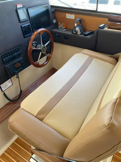 Come What May Yacht Photos Pics 2019 Ranger Tugs R-29 CB Luxury Edition helm with leather seating and wooden steering wheel.