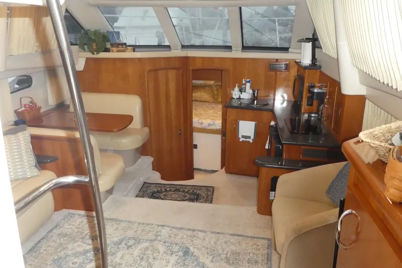  Yacht Photos Pics Interior of a 2006 Carver 366 Motor Yacht, featuring cozy seating and a compact kitchen area.