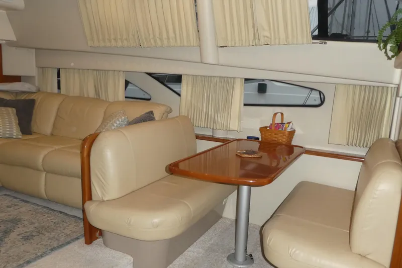  Yacht Photos Pics Interior of 2006 Carver 366 Motor Yacht with beige seating and wooden table.