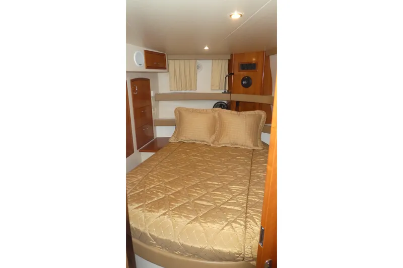  Yacht Photos Pics Interior cabin of 2006 Carver 366 Motor Yacht with cozy bed and wooden furnishings.