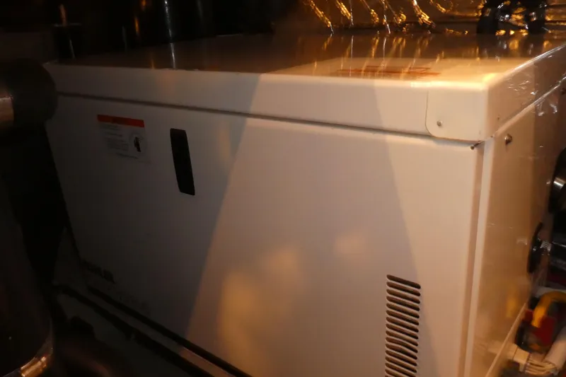  Yacht Photos Pics Engine room of 2006 Carver 366 Motor Yacht, featuring a white generator unit.