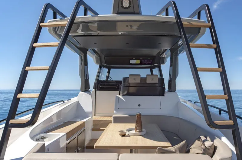  Yacht Photos Pics 2021 Bluegame BG42 yacht interior with seating, table, and ocean view.