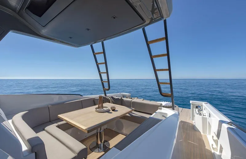  Yacht Photos Pics Luxury Bluegame BG42 yacht deck with seating, table, and ocean view, 2021 model.