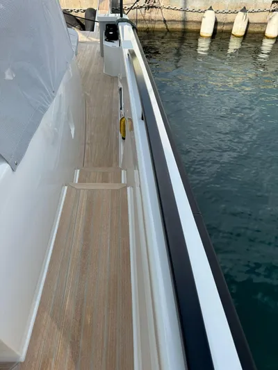  Yacht Photos Pics 2021 Bluegame BG42 yacht deck with wooden flooring by the water.