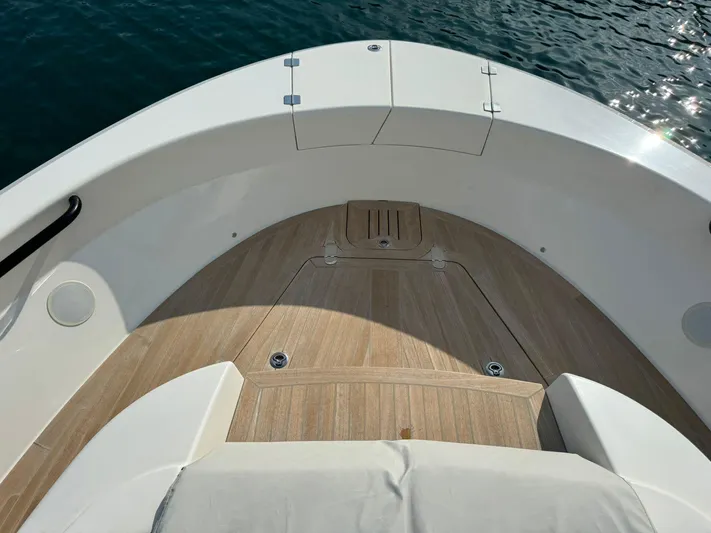  Yacht Photos Pics Bow view of 2021 Bluegame BG42 yacht with teak decking and white seating.