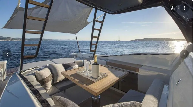  Yacht Photos Pics Luxurious 2021 Bluegame BG42 yacht interior with ocean view, featuring a cozy seating area.