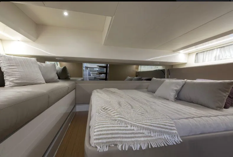  Yacht Photos Pics Luxurious interior of 2021 Bluegame BG42 yacht with cozy bedding and modern design.