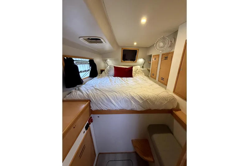 Waxy Yacht Photos Pics Cozy cabin interior of 2021 Celtic Yachts 40, featuring a comfortable bed and wooden storage.