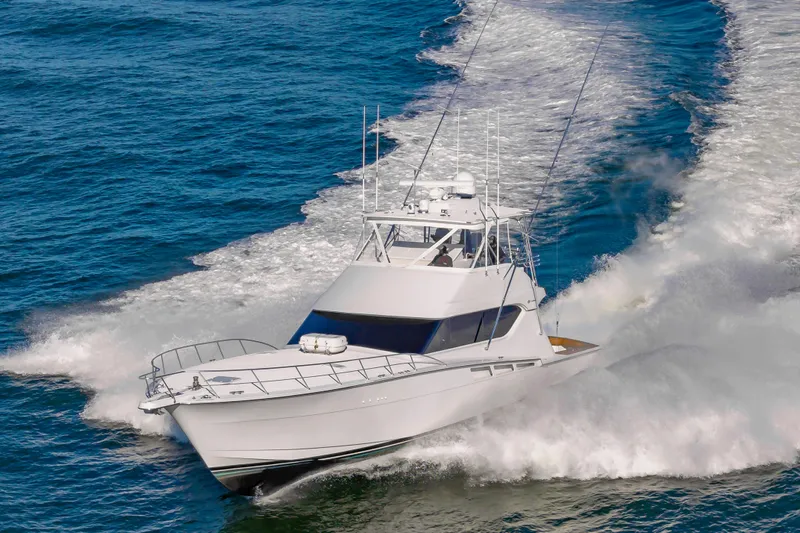 Sea Trader Yacht Photos Pics 2005 Hatteras 60 Convertible yacht cruising swiftly on open water.