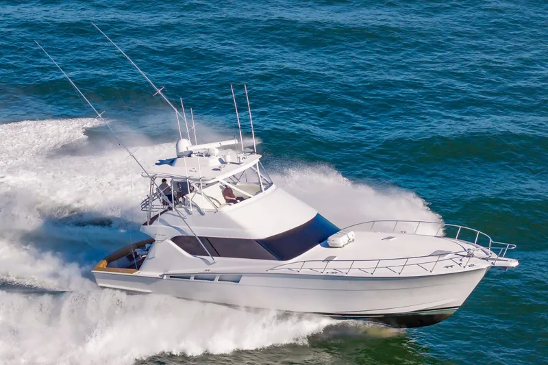 Sea Trader Yacht Photos Pics 2005 Hatteras 60 Convertible yacht cruising on open water.