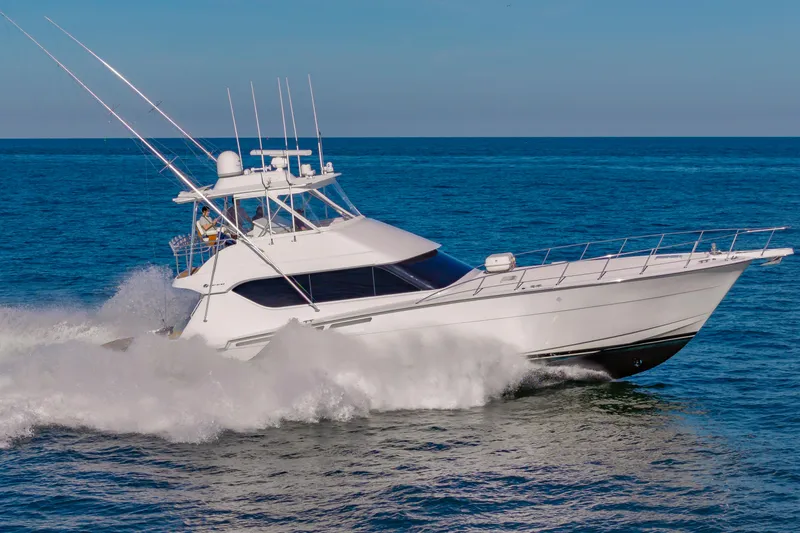 Sea Trader Yacht Photos Pics 2005 Hatteras 60 Convertible yacht cruising on open sea.