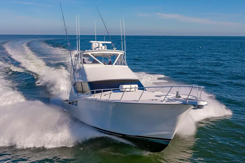 Sea Trader Yacht Photos Pics 2005 Hatteras 60 Convertible yacht cruising on open sea.