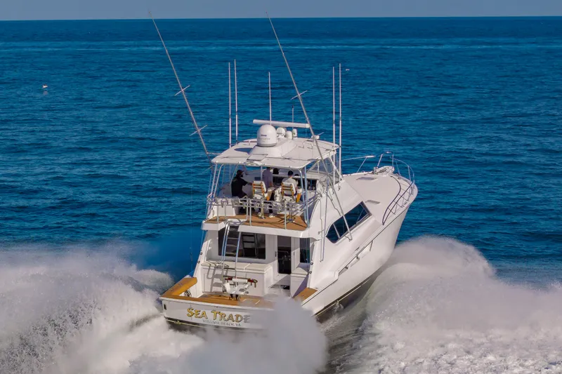 Sea Trader Yacht Photos Pics 2005 Hatteras 60 Convertible yacht cruising through ocean waves.