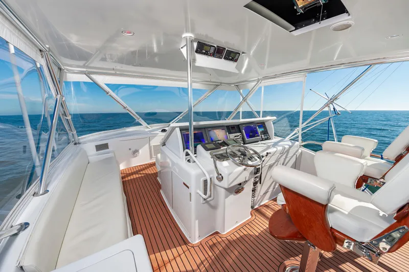 Sea Trader Yacht Photos Pics Luxurious 2005 Hatteras 60 Convertible yacht cockpit with ocean view and modern controls.