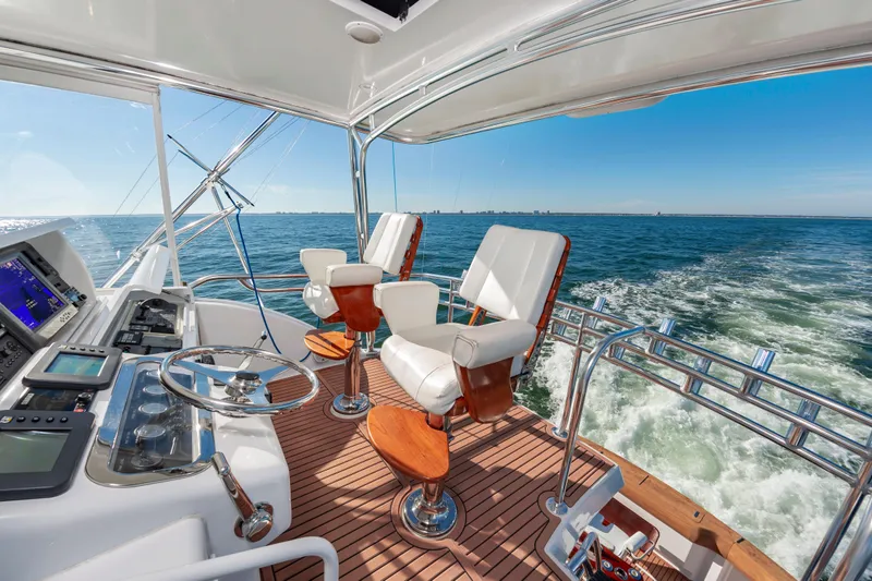 Sea Trader Yacht Photos Pics Luxurious 2005 Hatteras 60 Convertible yacht interior with ocean view and modern helm.