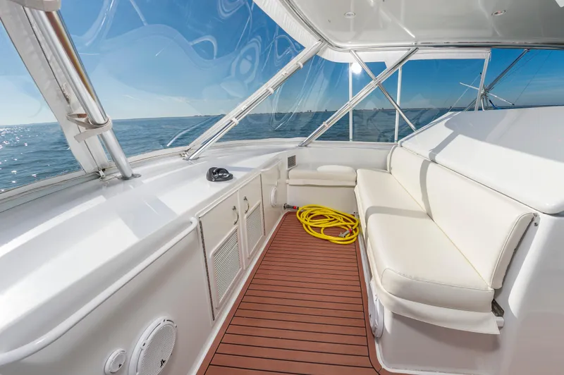 Sea Trader Yacht Photos Pics Interior of 2005 Hatteras 60 Convertible yacht with white seating and ocean view.