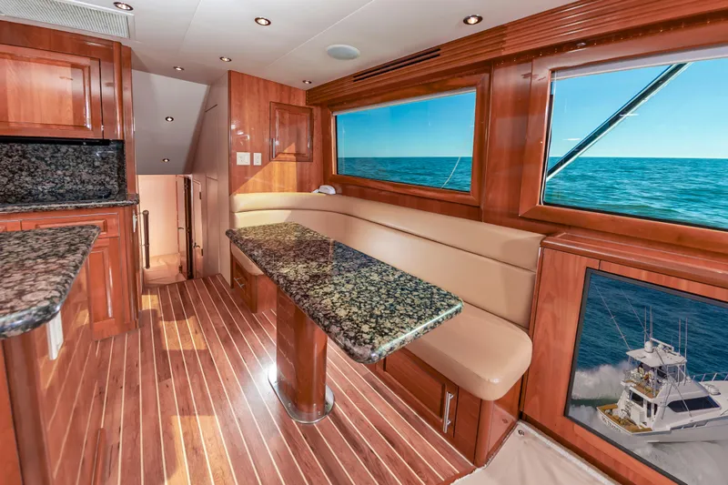 Sea Trader Yacht Photos Pics Luxurious 2005 Hatteras 60 Convertible yacht interior with wood finish and ocean view.