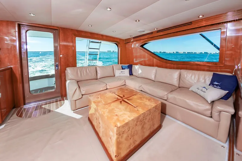 Sea Trader Yacht Photos Pics Luxurious interior of 2005 Hatteras 60 Convertible yacht with leather seating and ocean view.