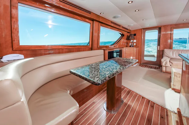 Sea Trader Yacht Photos Pics Luxurious 2005 Hatteras 60 Convertible yacht interior with elegant wood and leather finishes.