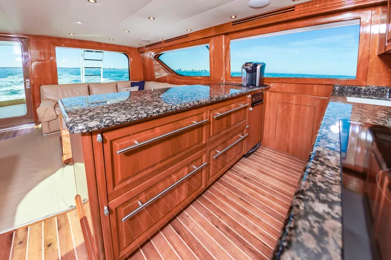 Sea Trader Yacht Photos Pics Luxurious interior of 2005 Hatteras 60 Convertible yacht with granite countertops and ocean view.