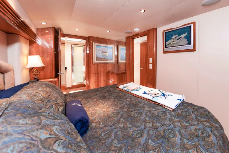 Sea Trader Yacht Photos Pics Luxurious bedroom interior of 2005 Hatteras 60 Convertible yacht with elegant decor.