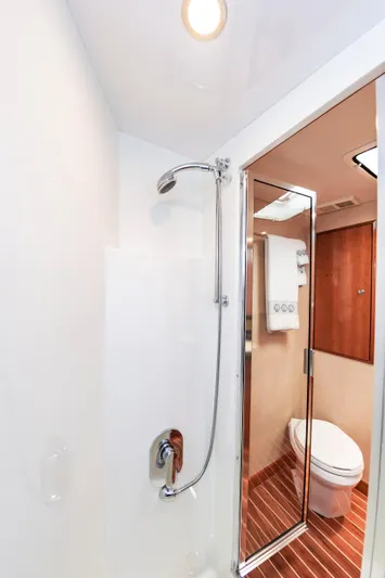 Sea Trader Yacht Photos Pics Bathroom interior of 2005 Hatteras 60 Convertible yacht with shower and toilet.