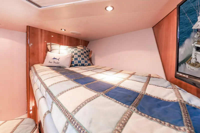 Sea Trader Yacht Photos Pics Cozy cabin interior of 2005 Hatteras 60 Convertible yacht with plaid bedding.