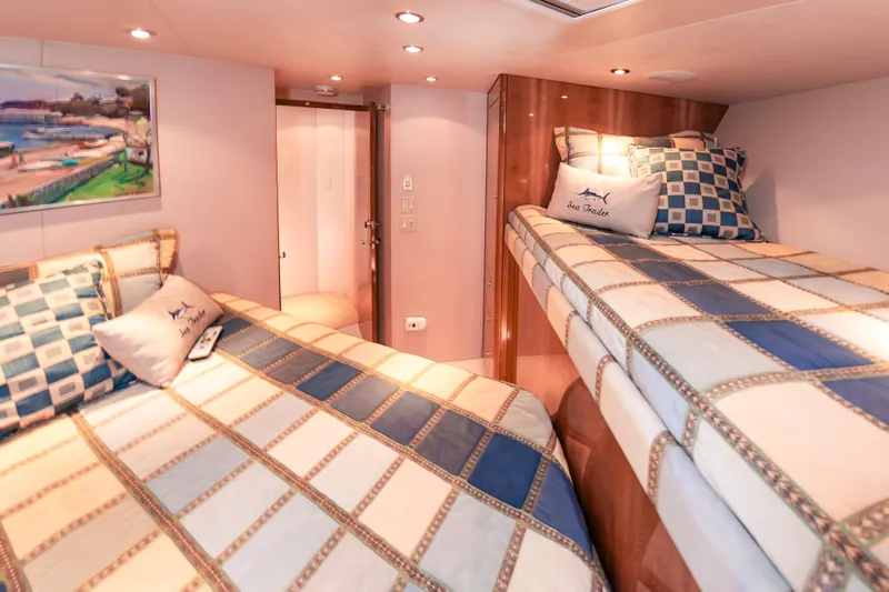 Sea Trader Yacht Photos Pics Cozy cabin interior of 2005 Hatteras 60 Convertible yacht with twin beds and nautical decor.