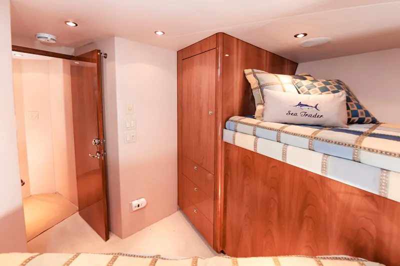 Sea Trader Yacht Photos Pics Cozy cabin interior of 2005 Hatteras 60 Convertible yacht with wooden furnishings.