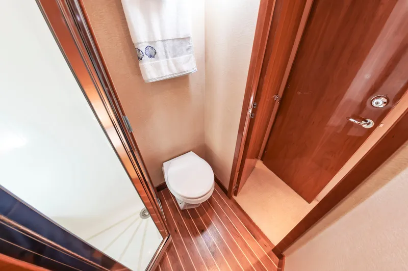 Sea Trader Yacht Photos Pics Bathroom interior of 2005 Hatteras 60 Convertible yacht with wooden flooring.