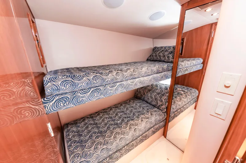 Sea Trader Yacht Photos Pics Bunk beds in 2005 Hatteras 60 Convertible yacht cabin with patterned bedding.