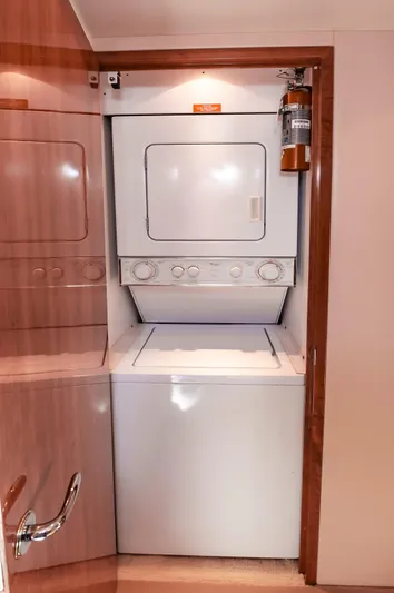 Sea Trader Yacht Photos Pics Stacked washer and dryer in 2005 Hatteras 60 Convertible yacht interior.
