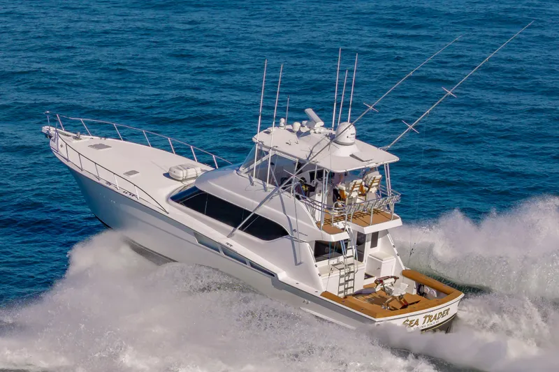 Sea Trader Yacht Photos Pics 2005 Hatteras 60 Convertible yacht cruising through ocean waves.
