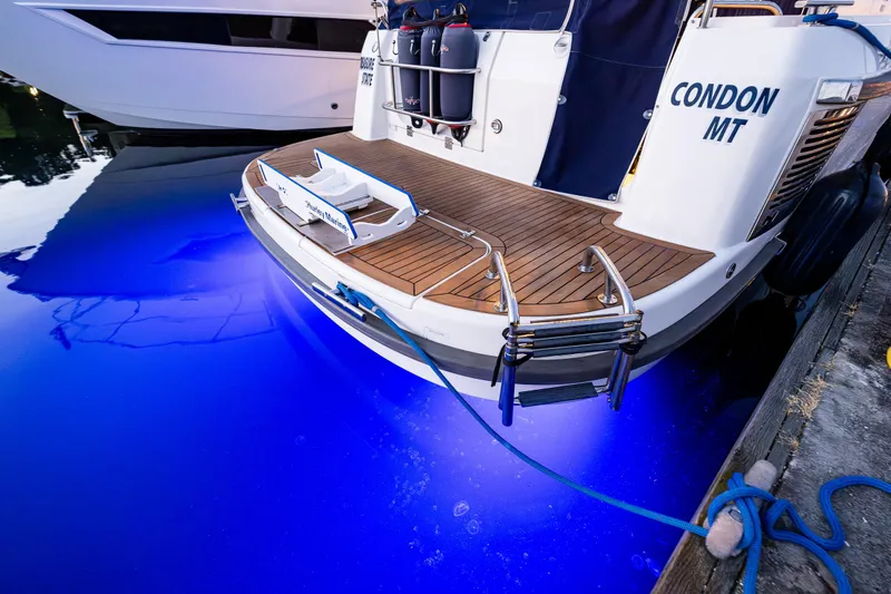 Treasure State Yacht Photos Pics Nimbus 405 Coup&eacute; 2022 yacht with illuminated blue water at dock.