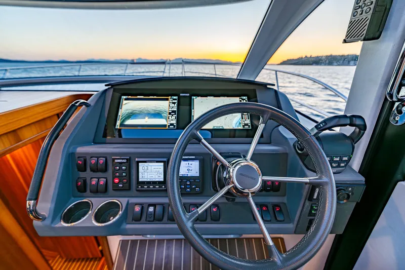 Treasure State Yacht Photos Pics 2022 Nimbus 405 Coup&eacute; yacht helm with advanced navigation systems at sunset.