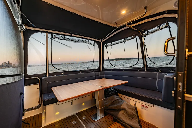 Treasure State Yacht Photos Pics Interior of 2022 Nimbus 405 Coup&eacute; boat with sunset view through windows.