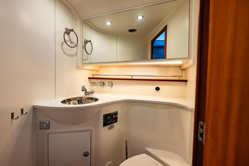 Treasure State Yacht Photos Pics Modern bathroom interior in 2022 Nimbus 405 Coup&eacute; yacht, featuring sleek fixtures and ambient lighting.