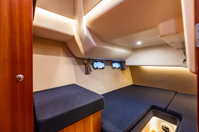 Treasure State Yacht Photos Pics Interior cabin of 2022 Nimbus 405 Coup&eacute; with cozy seating and porthole windows.