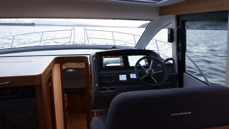 Treasure State Yacht Photos Pics Interior view of 2022 Nimbus 405 Coup&eacute; yacht cockpit with steering wheel and navigation controls.