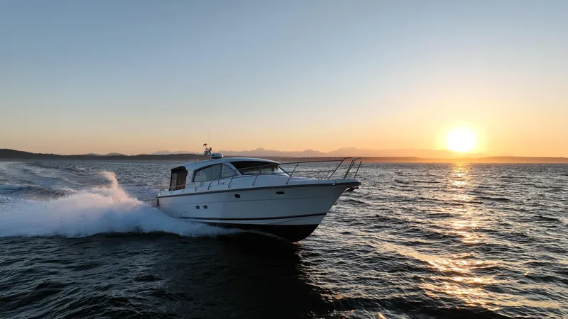 Treasure State Yacht Photos Pics Nimbus 405 Coup&eacute; 2022 cruising at sunset on open water.