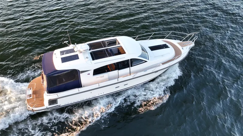 Treasure State Yacht Photos Pics 2022 Nimbus 405 Coup&eacute; cruising on open water, aerial view.