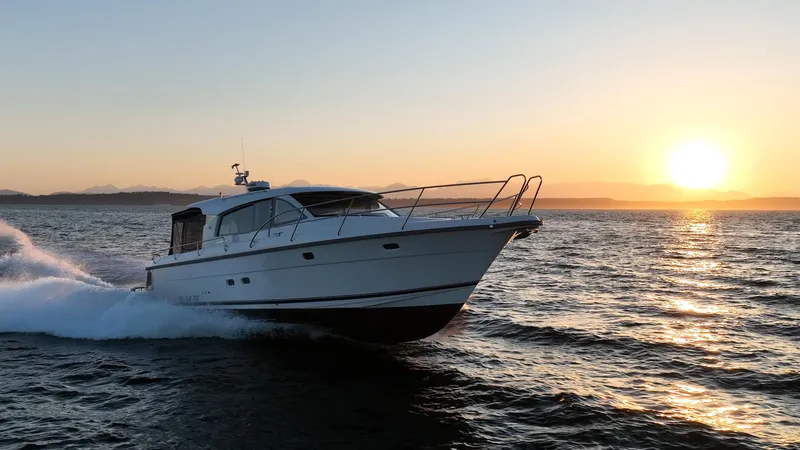 Treasure State Yacht Photos Pics Nimbus 405 Coup&eacute; 2022 cruising at sunset on open water.